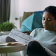 Black woman looking at bills